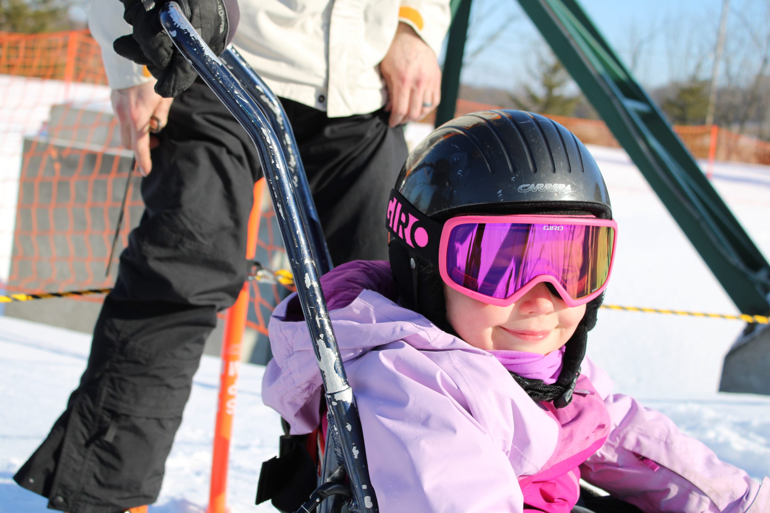 close-up of student in bi-ski smiling while wearing goggles